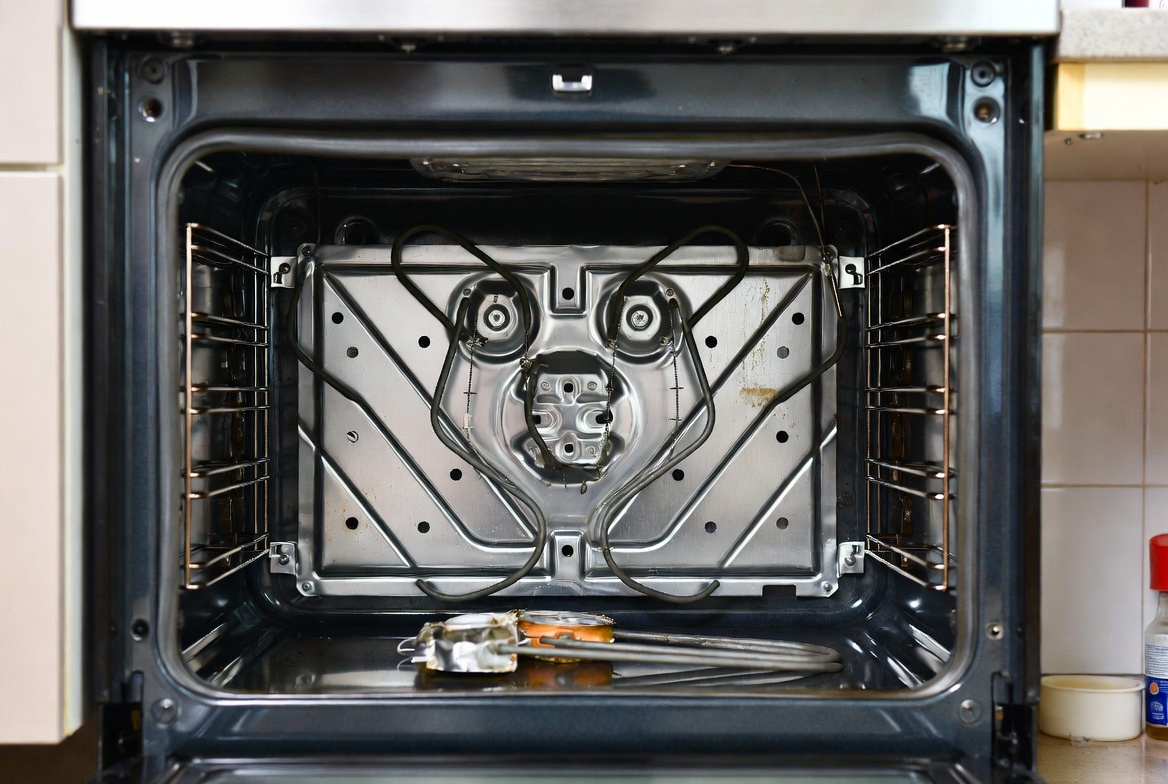 Oven heating element being replaced